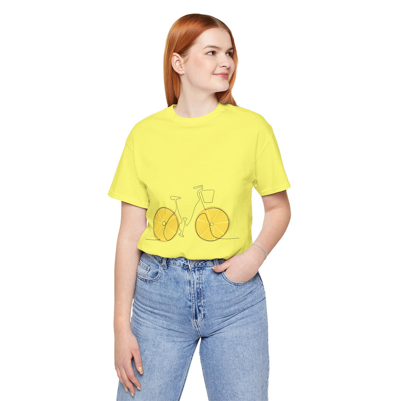 Person wearing a yellow t-shirt with a bicycle graphic and blue jeans on a white background